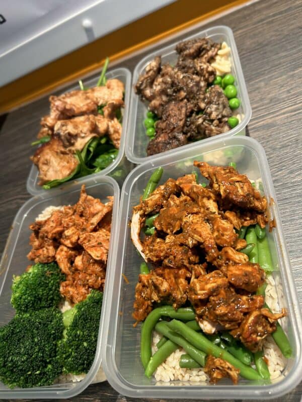Healthy meal prep with chicken, beef, and vegetable rice bowls for fitness and nutrition.