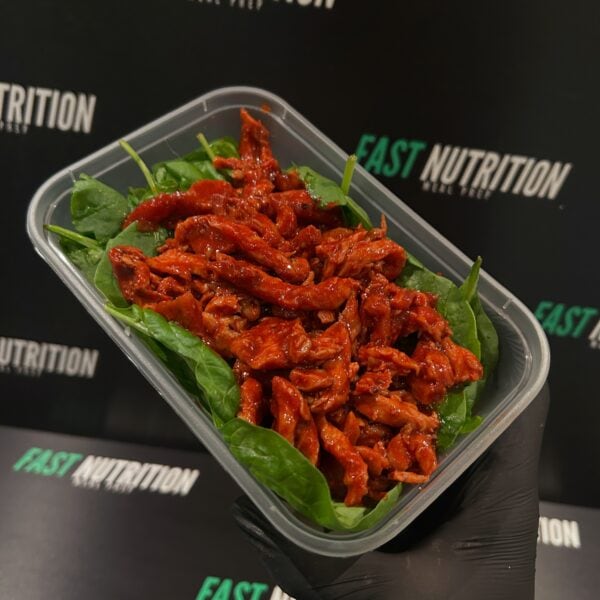 Delicious grilled chicken strips on fresh spinach leaves, perfect for healthy nutrition and high-protein meals.