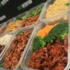 Healthy meal prep containers with nutritious fitness meals for muscle growth and diet plans.