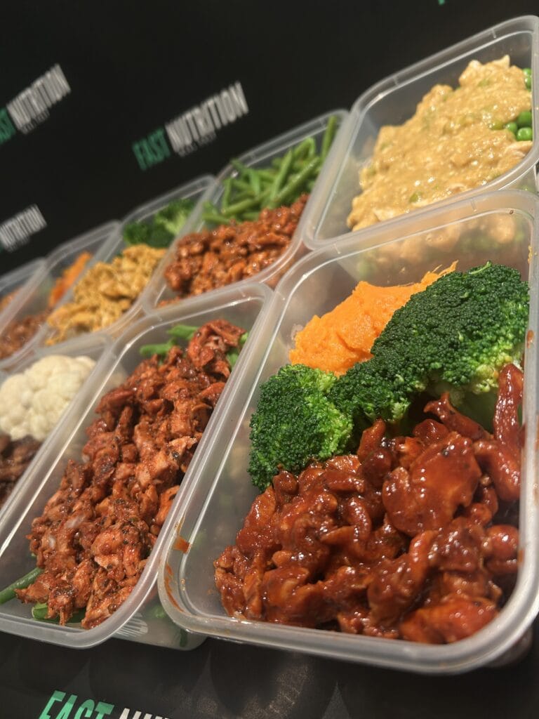 Healthy meal prep containers with nutritious fitness meals for muscle growth and diet plans.