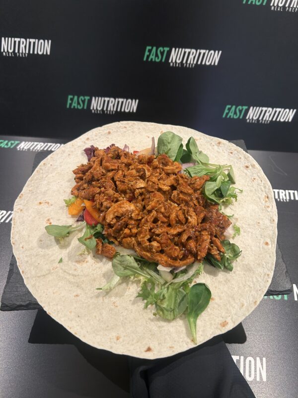Healthy meal prepped wrap with lean meat, fresh greens, and vegetables. Perfect for nutrition and muscle gain.