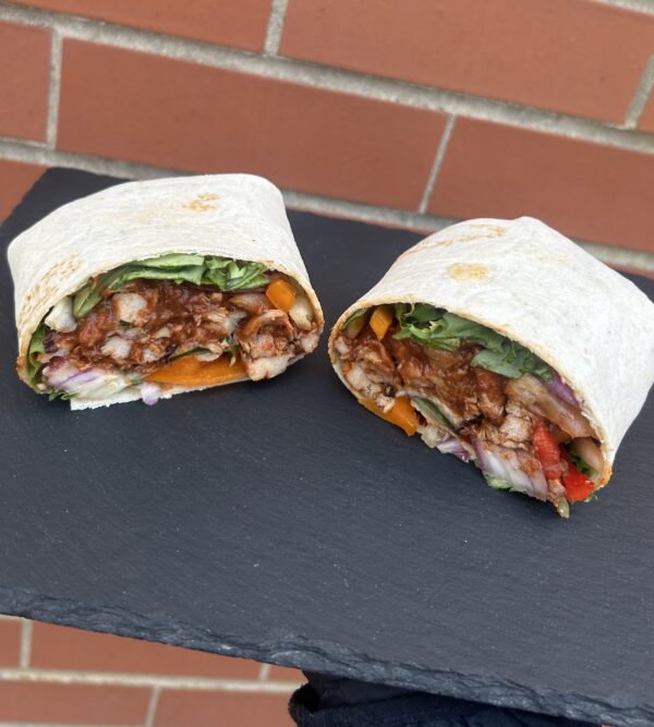 Healthy chicken wrap with fresh vegetables and lean protein, perfect for balanced nutrition.