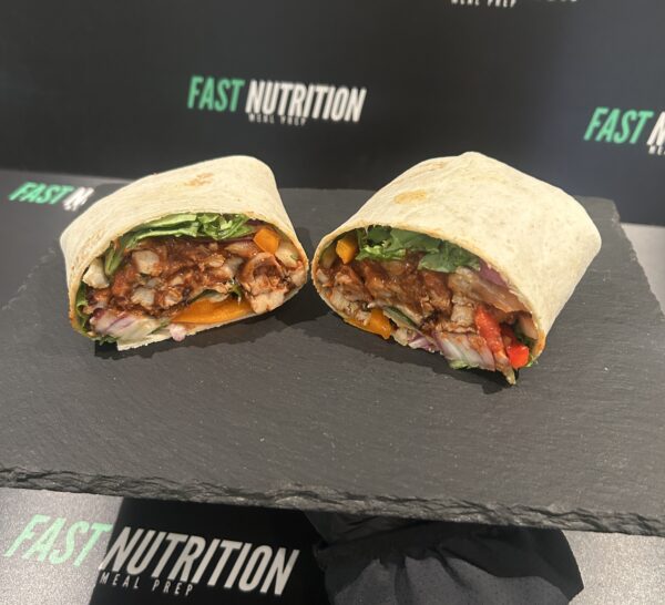 Vibrant wrap filled with chicken, fresh vegetables, and healthy grains. Perfect for a nutritious meal from Fast Nutrition.