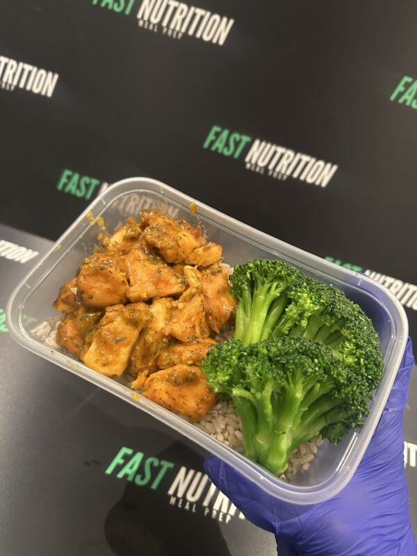 Nutritious chicken and broccoli meal in a meal prep container.