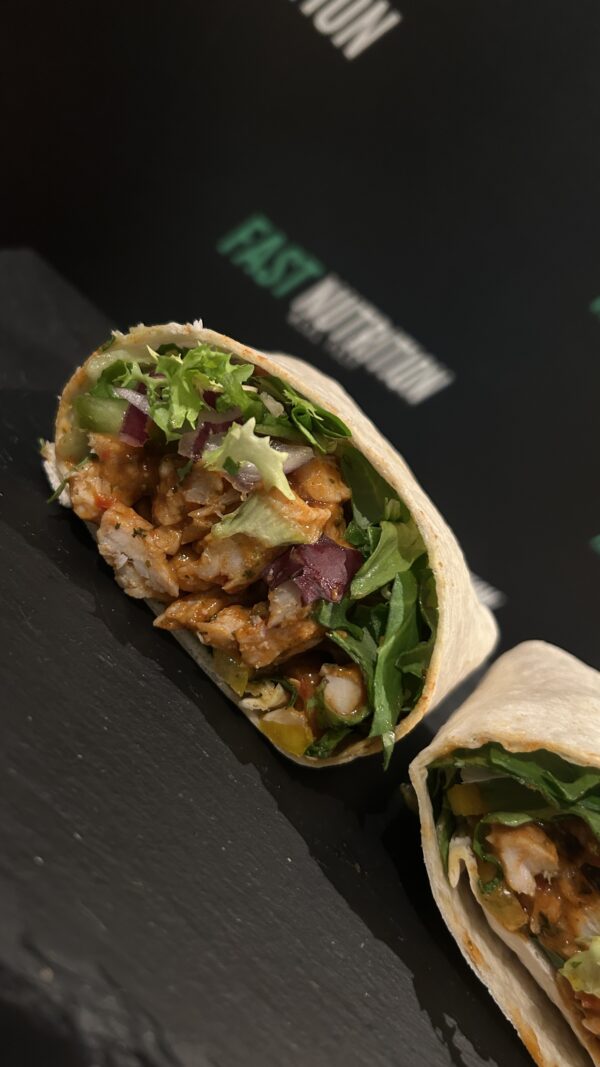Delicious nutritious wrap with lean chicken, fresh greens, and savoury sauce - perfect for active lifestyles.