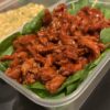 High-protein meal with tender steak strips, fresh greens, and tasty sauces for athletes and fitness enthusiasts.