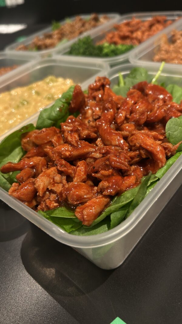High-protein meal with tender steak strips, fresh greens, and tasty sauces for athletes and fitness enthusiasts.
